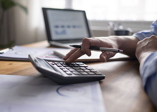 A man in an office using a calculator